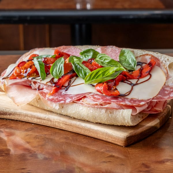 John's Deli Italian sub with salami, ham, cheese, roasted red peppers, basil, and balsamic glaze.