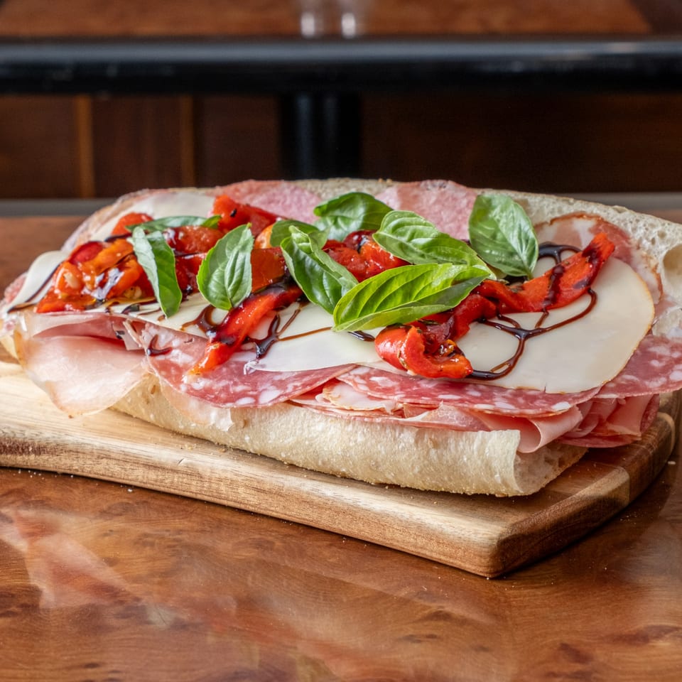 John's Deli Italian sub with salami, ham, cheese, roasted red peppers, basil, and balsamic glaze.